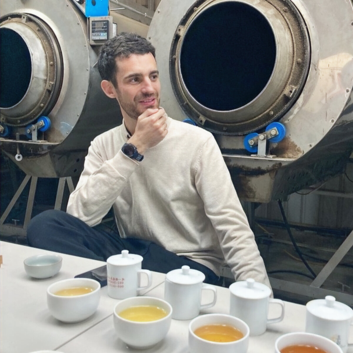José Ellena at a tea cupping table in a tea factory