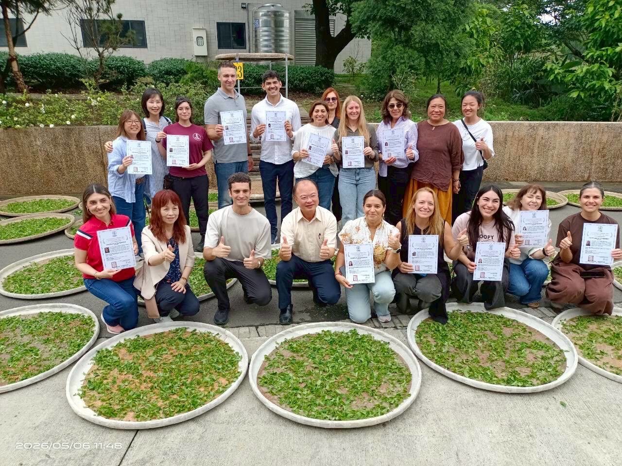 Course group photo with tea withering trays